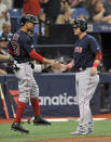 Boston Red Sox's Mookie Betts, left, and Steve Pearce celebrate after scoring on Xander Bogaerts' two-run single off Tampa Bay Rays reliever Chaz Roe during the sixth inning of a baseball game Sunday, April 21, 2019, in St. Petersburg, Fla. (AP Photo/Steve Nesius)