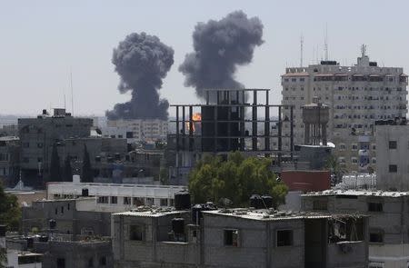 Smoke and flames are seen following what witnesses said were Israeli air strikes in Rafah in southern Gaza in this August 1, 2014 file photo. REUTERS/Ibraheem Abu Mustafa/Files