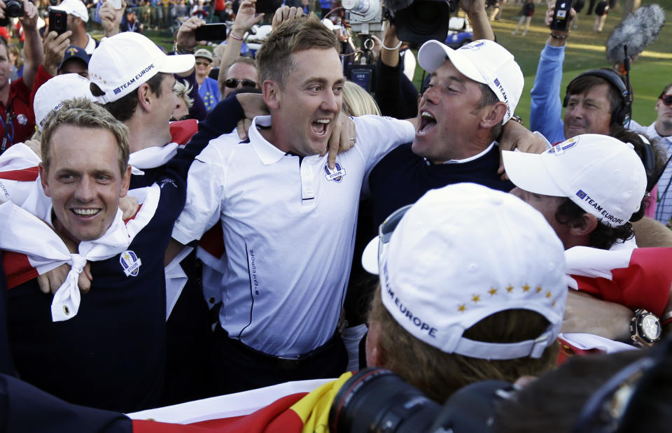 Europe's Luke Donald, , left, Ian Poulter, center, Lee Westwood and Rory McIlroy, obscured at far right, celebrate after winning the Ryder Cup PGA golf tournament at the Medinah Country Club in Medinah, Ill., in this Sunday, Sept. 30, 2012, file photo. (AP Photo/David J. Phillip, File)