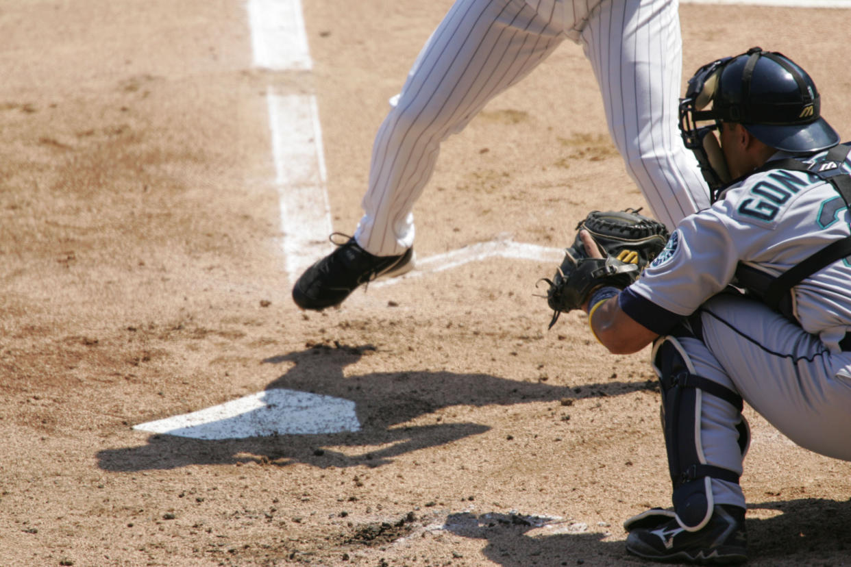 A catcher sets up behind home plate.