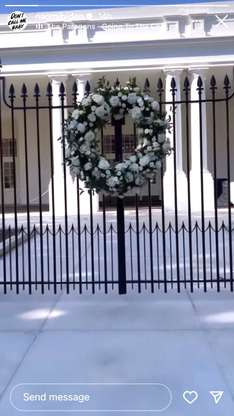 A floral wreath on a gate at the White House before Naomi Biden's wedding