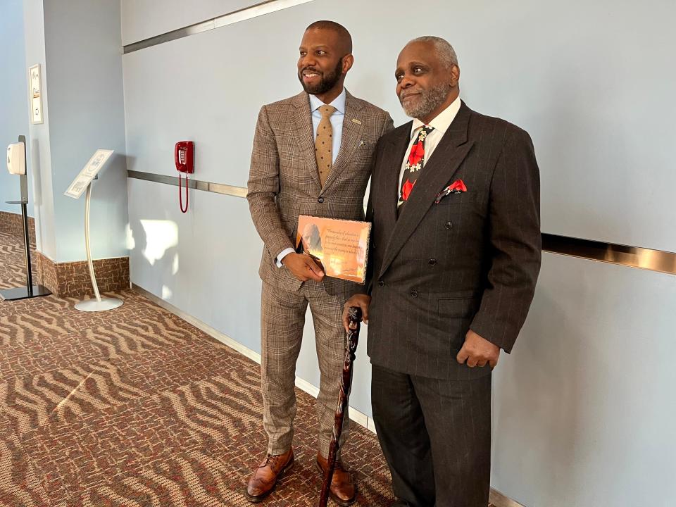 Ivory Toldson, left, gets his photo with a commemorative plaque created by artist Woodrow Nash. The plaque was presented at the 2023 Akron NAACP Freedom Fund fundraiser event Sunday at the John S. Knight Center.
