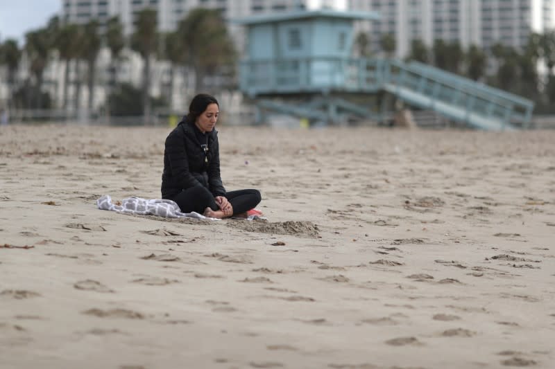 Middle school teacher Nicole Buzzelli, 27, sits on the beach after her school was closed during the global outbreak of coronavirus disease (COVID-19) in Santa Monica