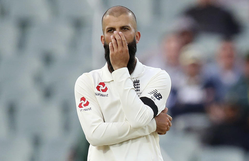FILE - In this Dec. 2, 2017, file photo, England's Moeen Ali puts his hand over his face after bowling to an Australian batsman during their Ashes test match in Adelaide. Team allrounder Ali was isolating in Sri Lanka on Monday, Jan. 4, 2021, after testing positive for the coronavirus upon his arrival in the South Asian country for the team's two-test cricket tour. (AP Photo/Rick Rycroft, File)