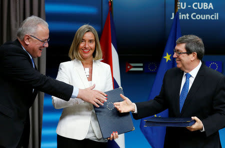 European International Cooperation and Development Commissioner Neven Mimica, European Union foreign policy chief Federica Mogherini and Cuba's Foreign Minister Bruno Rodriguez pose after a signing ceremony of a cooperation agreement at the EU Council in Brussels, Belgium May 15, 2018. REUTERS/Francois Lenoir