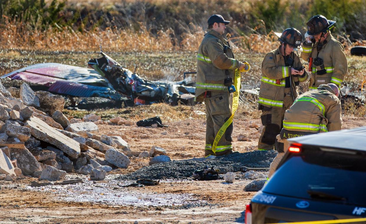 An Oklahoma City Fire Department crew works the scene of a plane crash Sunday near Wiley Post Airport.