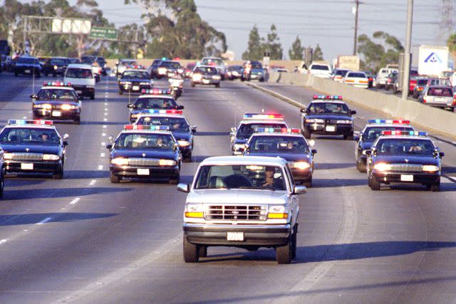 <p>Allen J. Schaben/Los Angeles Times/Getty</p> California Highway Patrol chase Al Cowlings, driving, and O.J. Simpson, hiding in rear of white Bronco on the 91 Freeway.