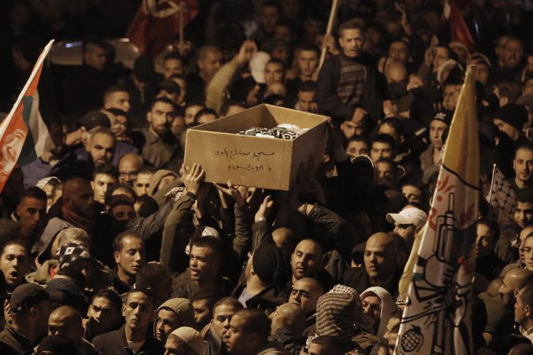 Palestinian mourners attend the funeral of bus driver Yusuf Hasan al-Ramuni in the West Bank town of Abu Dis from Jerusalem on November 17, 2014