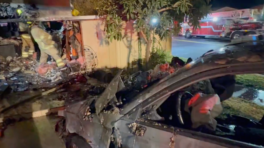 Firefighters respond after a car rammed into a home in Irvine on Jan. 8, 2024.