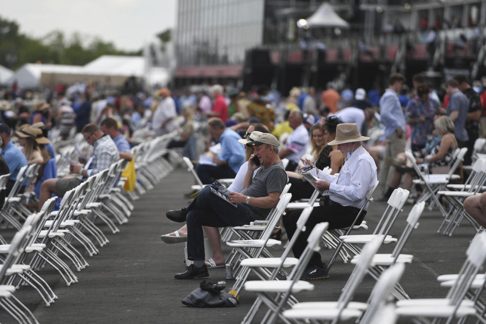 Spectators are seen in prior to an undercard race ahead of the Preakness Stakes horse race at Pimlico Race Course, Saturday, May 15, 2021, in Baltimore. (AP Photo/Will Newton)