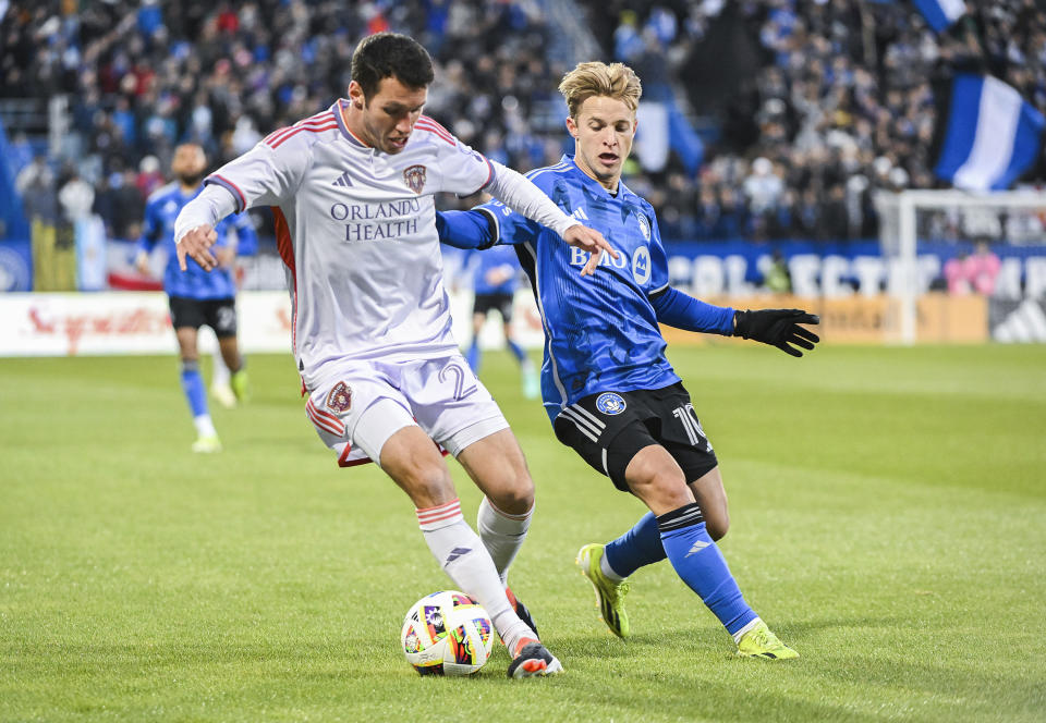 CF Montreal midfielder Bryce Duke, right, challenges Orlando City's Kyle Smith during the first half of an MLS soccer match Saturday, April 20, 2024, in Montreal. (Graham Hughes/The Canadian Press via AP)