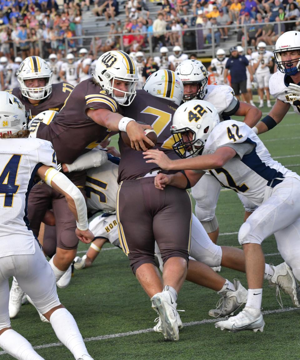 Western Brown quarterback Drew Novak reaches the ball over the goal line for a Broncos touchdown against Monroe Friday, Sept. 2.