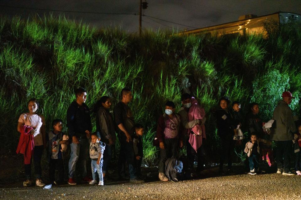 Migrant families are lined up after crossing the U.S.-Mexico border in Roma, Texas on July 9, 2021. / Credit: PAUL RATJE/AFP via Getty Images