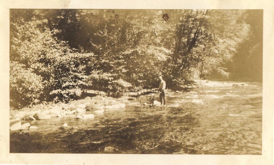 George Masa wasn’t only content to capture the beauty of the Smokies on film. Pictured here, Masa was often seen taking detailed notes and using a modified bicycle wheel odometer to carefully measure distances between landmarks for the benefit of mapmakers and landmark-naming committees.