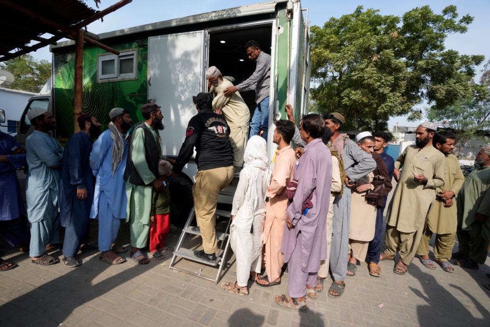 Immigrants, mostly Afghans, line up as they wait for their turn to verify data at a counter of Pakistan’s National Database and Registration Authority in Karachi (AP)