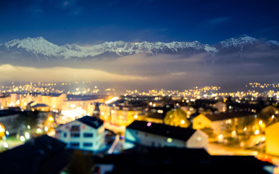 Traditional buildings line the river in Innsbruck - Gergo Kazsimer