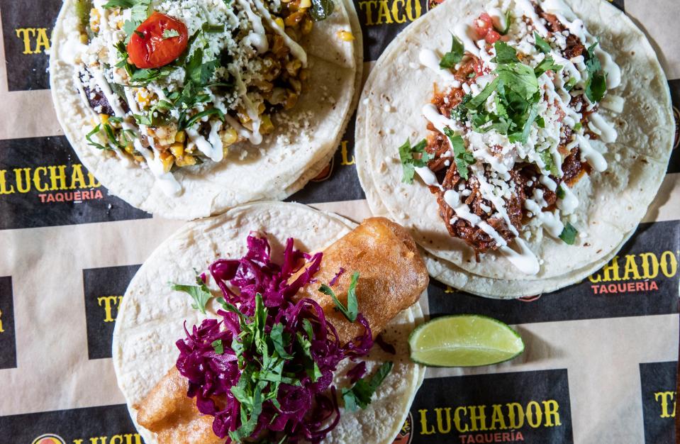 Three tacos from Taco Luchador: The Barbacoa with braised short ribs, Baja Fish that has Mexican beer battered and Veggie. Some of the ingredients include poblanos, guacamole, pickled cabbage and crema.