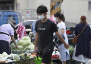 People wear face masks to help protect against the spread of the coronavirus as they shop in outdoor markets in Taipei, Taiwan, Monday, Sept. 27, 2021. (AP Photo/Chiang Ying-ying)