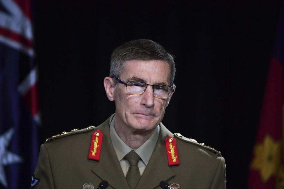 Chief of the Australian Defence Force Gen. Angus Campbell delivers the findings from the Inspector-General of the Australian Defence Force Afghanistan Inquiry, in Canberra, Thursday, Nov. 19, 2020. A shocking report into war crimes by elite Australian troops has found evidence that 25 soldiers unlawfully killed 39 Afghan prisoners, farmers and civilians. (Mick Tsikas/Pool Photo via AP)