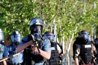 Police officers face protesters after a white police officer was caught on a bystander's video pressing his knee into the neck of African-American man George Floyd, who later died at a hospital, in St. Paul