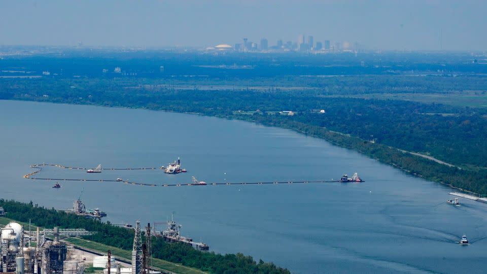 Dredging operations to build an underwater sill are seen in this aerial image, with the city of New Orleans in the background. - Gerald Herbert/AP