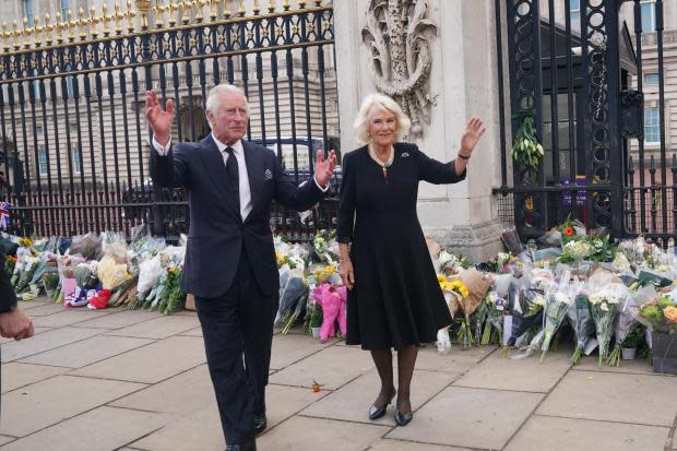 King Charles III and the Queen Consort view tributes left outside Buckingham Palace