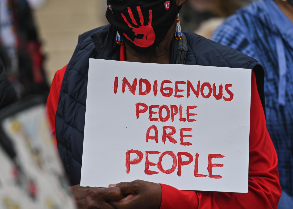 A participant holds a placard with words 'Indigenious People Are People'.
Hundreds of women participated in the annual Red Dress Day march in downtown Edmonton, hosted by Project REDress, commemorating the lives of missing and murdered indigenous women and girls across Canada.
On Thursday, 5 May 2022, in Edmonton, Alberta, Canada. (Photo by Artur Widak/NurPhoto via Getty Images)