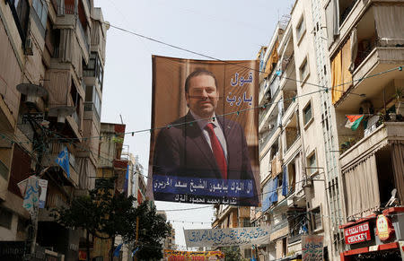 A campaign banner of Lebanese Prime Minister and candidate for parliamentary election Saad al-Hariri hangs over a street in Beirut, Lebanon May 3, 2018. REUTERS/Jamal Saidi