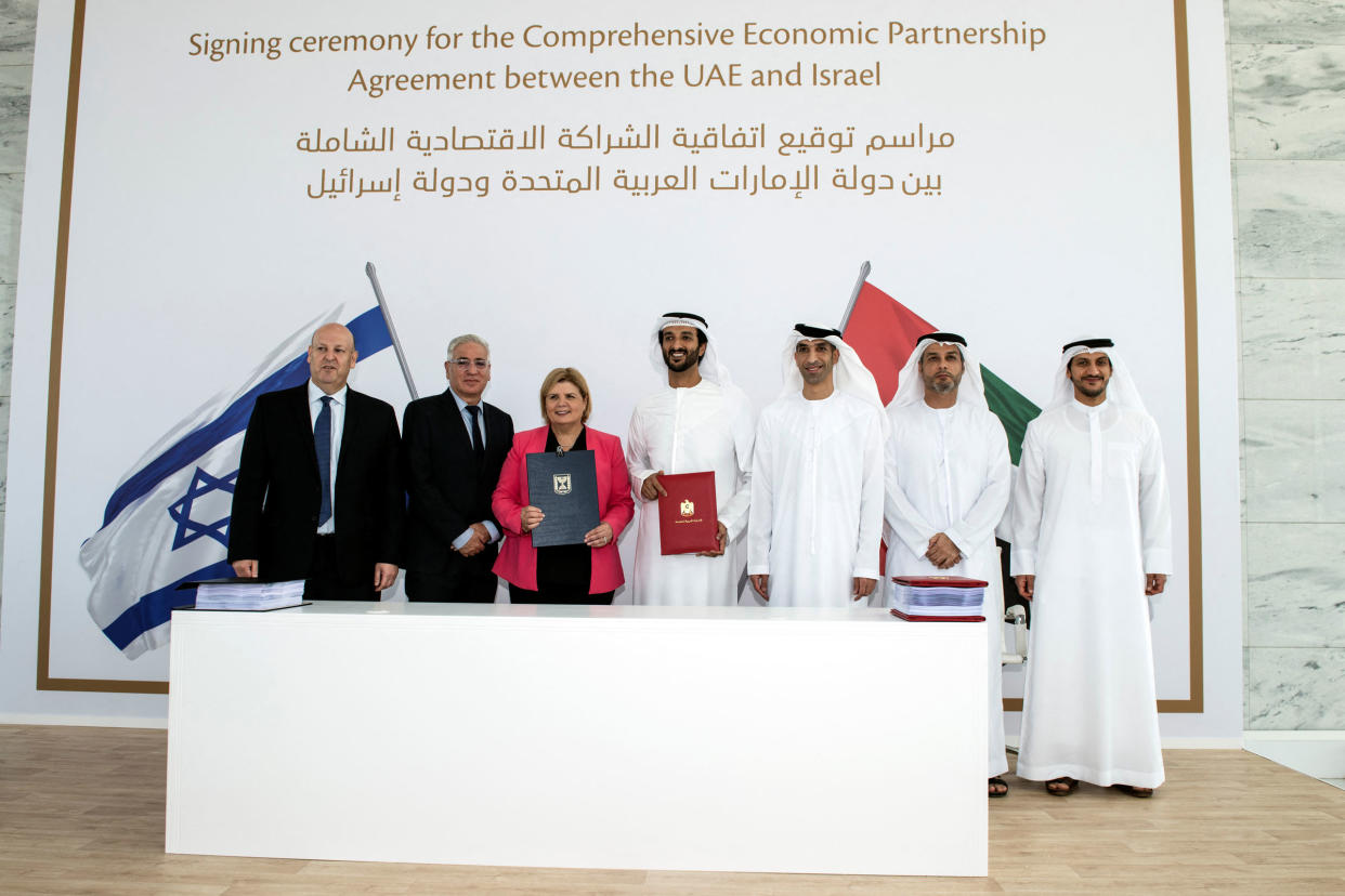 Israel's Minister of Economy and Industry Orna Barbivai, UAE Minister of Economy Abdulla bin Touq Al Marri and other officials present the Free Trade Agreement they signed