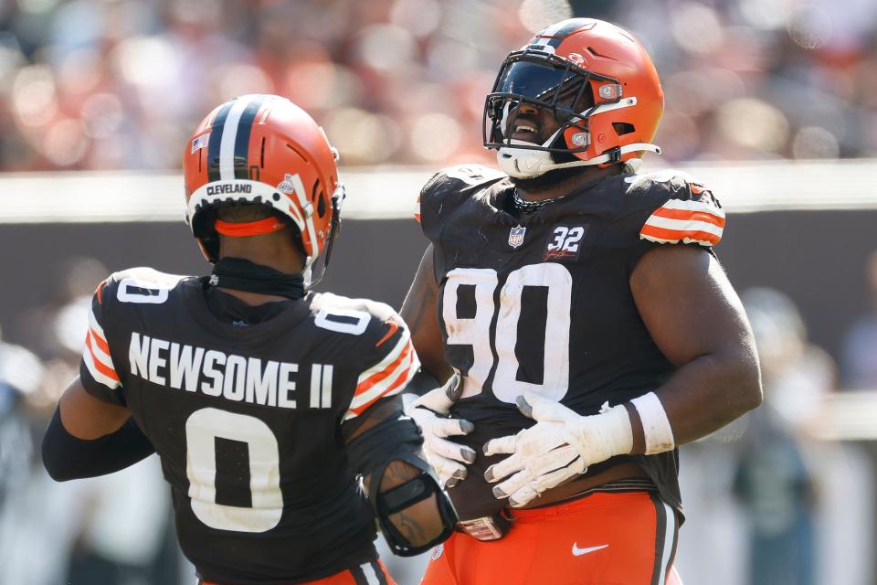 Cleveland Browns cornerback Greg Newsome II (0) and defensive tackle Maurice Hurst II (90) celebrate after a stop on third down against the Baltimore Ravens on Oct. 1, 2023, in Cleveland.