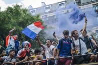 <p>People hold French national flags as they stand on a bus prior to the start of the Russia 2018 World Cup final football match between France and Croatia, in Paris on July 15, 2018. (Getty Images) </p>