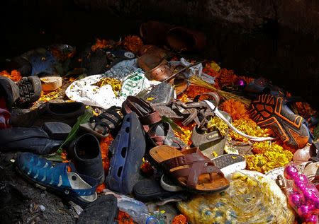 Footwear of the victims of a stampede are seen below a railway station's pedestrian overbridge in Mumbai, India September 29, 2017. REUTERS/Shailesh Andrade