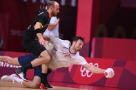 <p>Norway's right back Magnus Abelvik Rod (R) tries to reach the ball past Germany's left wing Marcel Schiller during the men's preliminary round group A handball match between Germany and Norway of the Tokyo 2020 Olympic Games at the Yoyogi National Stadium in Tokyo on July 30, 2021. (Photo by Daniel LEAL-OLIVAS / AFP) (Photo by DANIEL LEAL-OLIVAS/AFP via Getty Images)</p> 