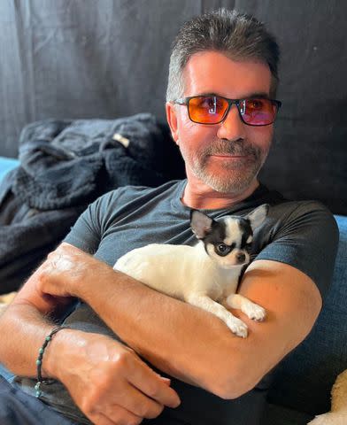 <p>Simon Cowell/Instagram</p> Simon Cowell cuddles adorable black and white puppy