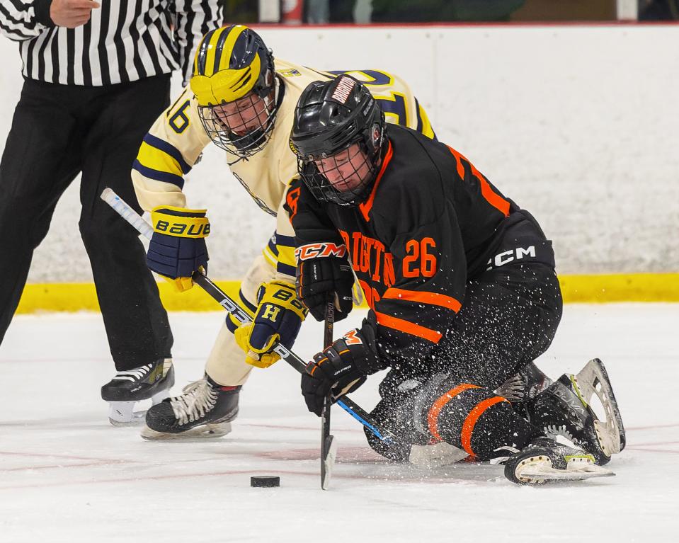 Brighton's Charlie Burchfield (26) battles Hartland's Ian Kastamo (16) on a faceoff Saturday, Nov. 25, 2023.