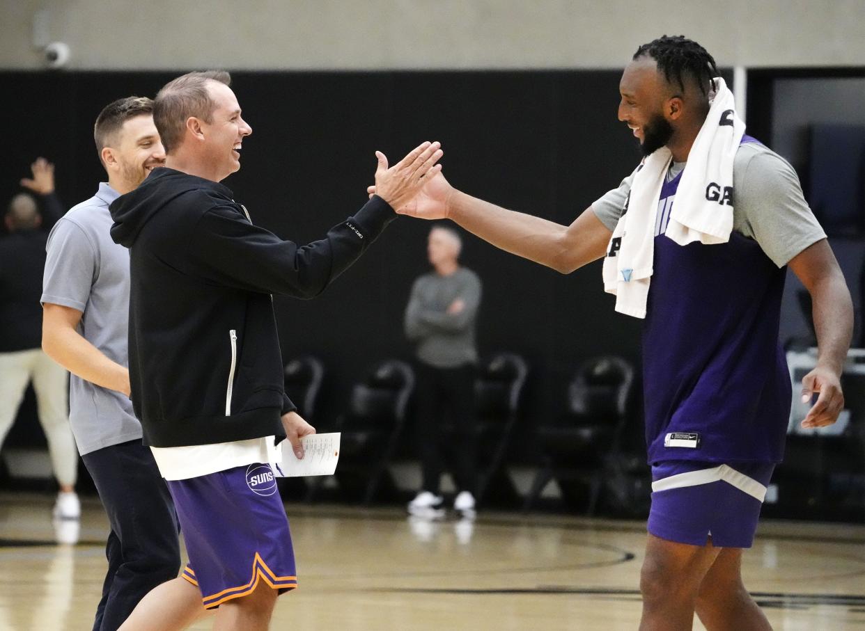 Phoenix Suns head coach Frank Vogel high-fives forward Josh Okogie during training camp at the Verizon 5G Performance Center facility in Phoenix on Oct. 4, 2023.