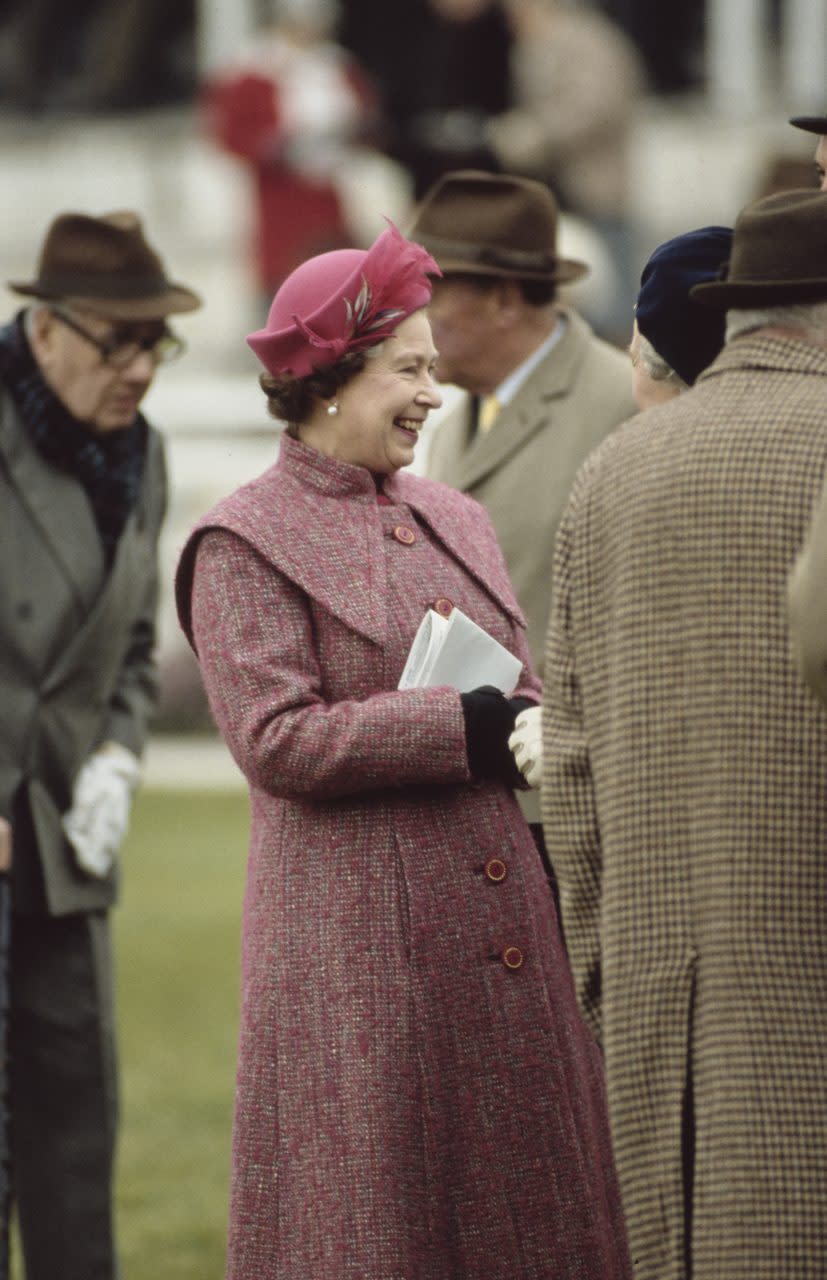 British Royal Queen Elizabeth II, wearing a pink-and-grey checked coat with a pink hat, at Sandown Park Racecourse in Esher, Surrey, England, 13th March 1987. The Queen was attending to see her daughter, Anne, Princess Royal, racing her horse Croc Na Cuille. (Photo by Tim Graham Photo Library via Getty Images)