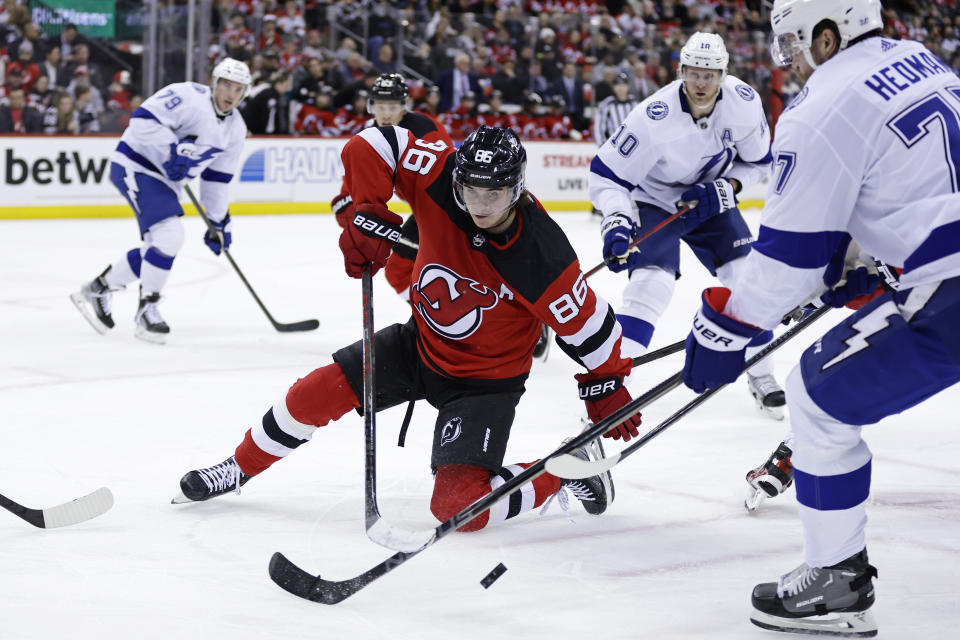 New Jersey Devils center Jack Hughes (86) battles for a face-off with Tampa Bay Lightning defenseman Victor Hedman during the second period of an NHL hockey game Tuesday, March 14, 2023, in Newark, N.J. (AP Photo/Adam Hunger)