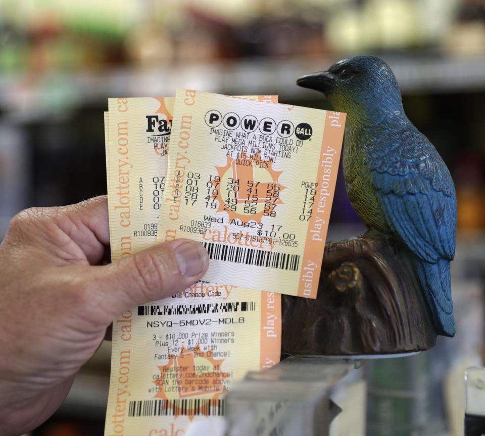 <p>A man shows his Powerball lottery tickets at the Bluebird Liquor store in Hawthorne, Calif., Aug. 23, 2017. (Photo: Mike Nelson/EPA/REX/Shutterstock) </p>