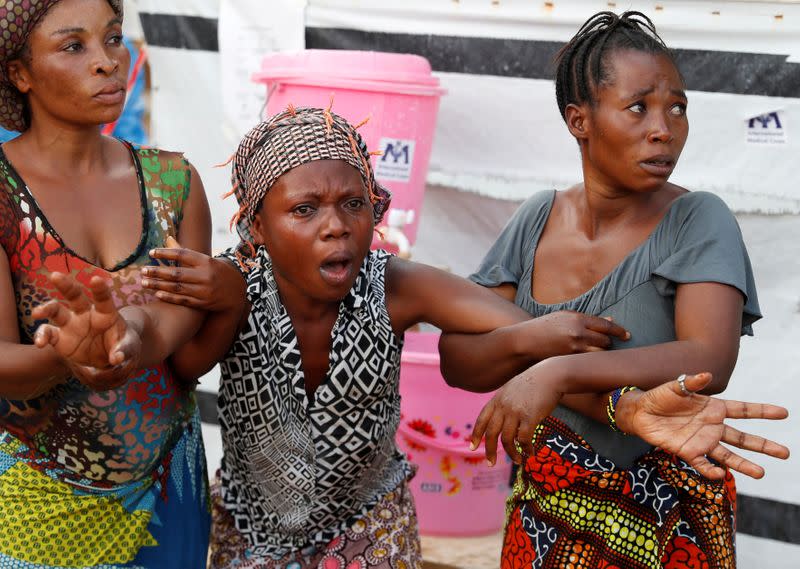 FILE PHOTO: A mother of a child, suspected of dying from Ebola, cries outside a hospital during the funeral in Beni