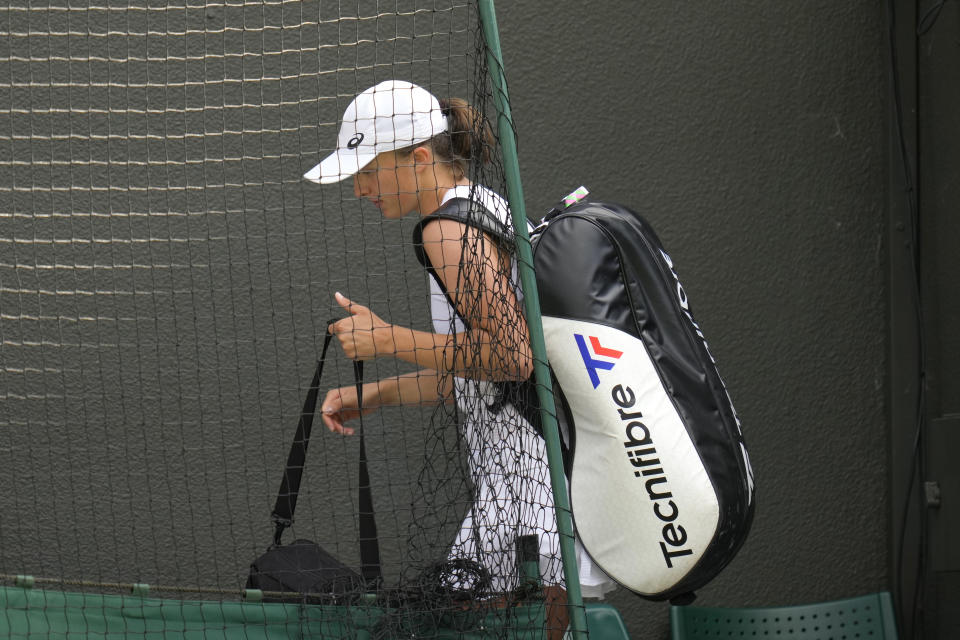 FILE - Poland's Iga Swiatek leaves the court after losing to France's Alize Cornet in a third round women's singles match on day six of the Wimbledon tennis championships in London, Saturday, July 2, 2022. All of what she does so well on clay or hard courts seemingly should translate just fine to grass. (AP Photo/Kirsty Wigglesworth, FIle)