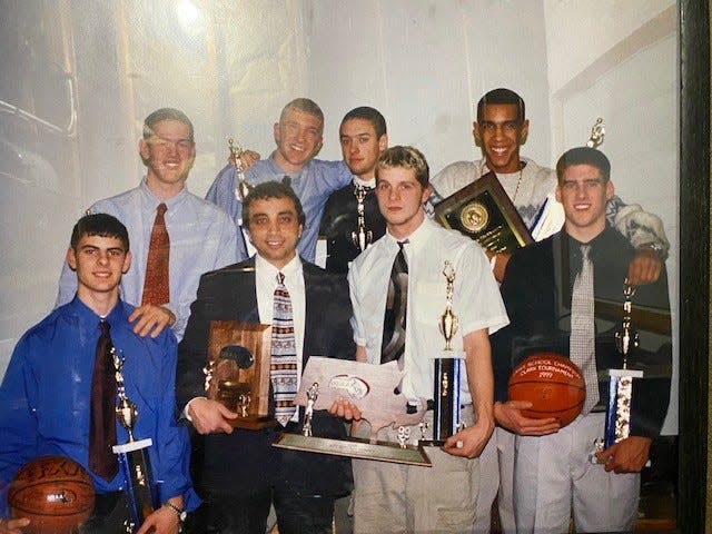 The Quabbin basketball seniors and coach Dennis Dextradeur present their awards from their successful season in 1999. The team, which won the Central Mass. title and the Clark Tournament, is being celebrated at the Quabbin boys basketball game on February 2, 2024.