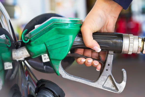 Female hand refilling the car with fuel