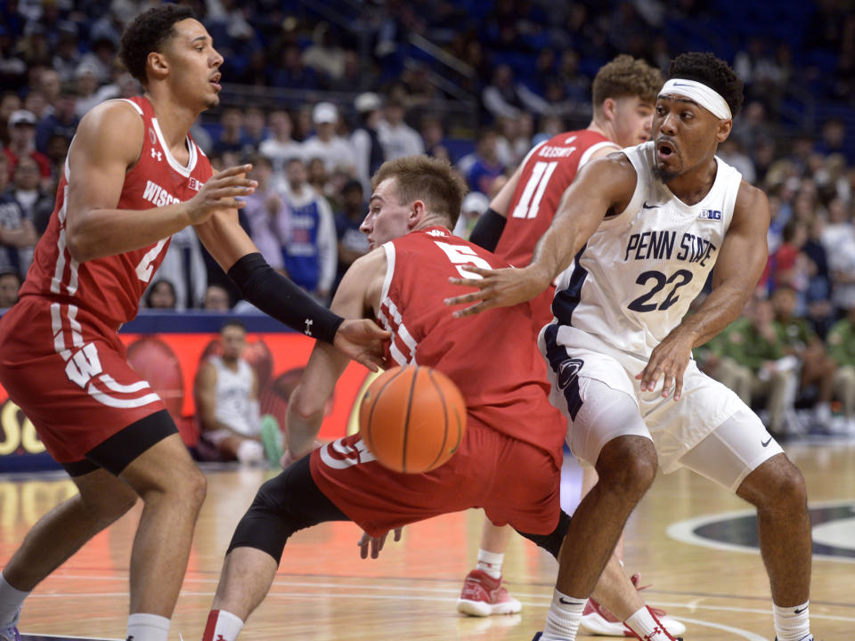 Penn State's Jalen Pickett (22) makes a bounce pass behind Wisconsin's Tyler Wahl (5) during the first half of an NCAA college basketball game, Wednesday, Feb. 8, 2023, in State College, Pa. (AP Photo/Gary M. Baranec)