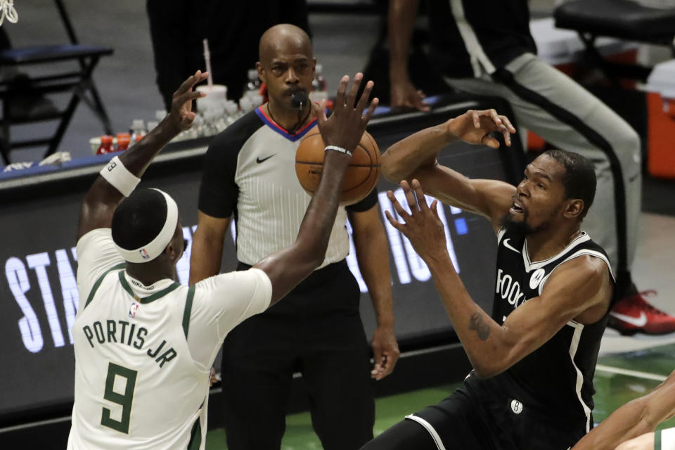 Brooklyn Nets' Kevin Durant is fouled as he shoots against Milwaukee Bucks' Bobby Portis (9) during the first half of an NBA basketball game Tuesday, May 4, 2021, in Milwaukee. (AP Photo/Aaron Gash)