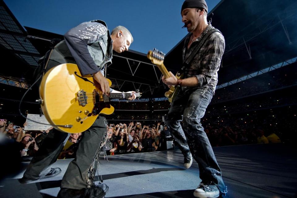 Adam Clayton (L) and The Edge of Irish rock group U2 perform at Wembley Stadium in their 360 tour (AFP/Getty Images)