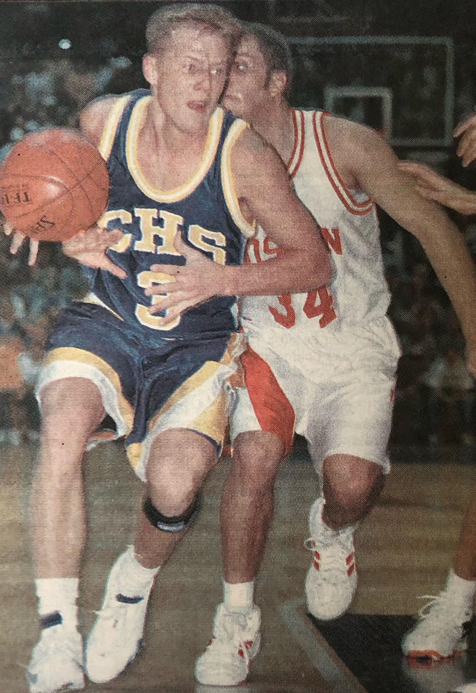 Castlewood's Dallas Sikkink drives past Roslyn's Jeremy Hendrickson during their semifinal game in the 2001 state Class B boys basketball tournament at Aberdeen.