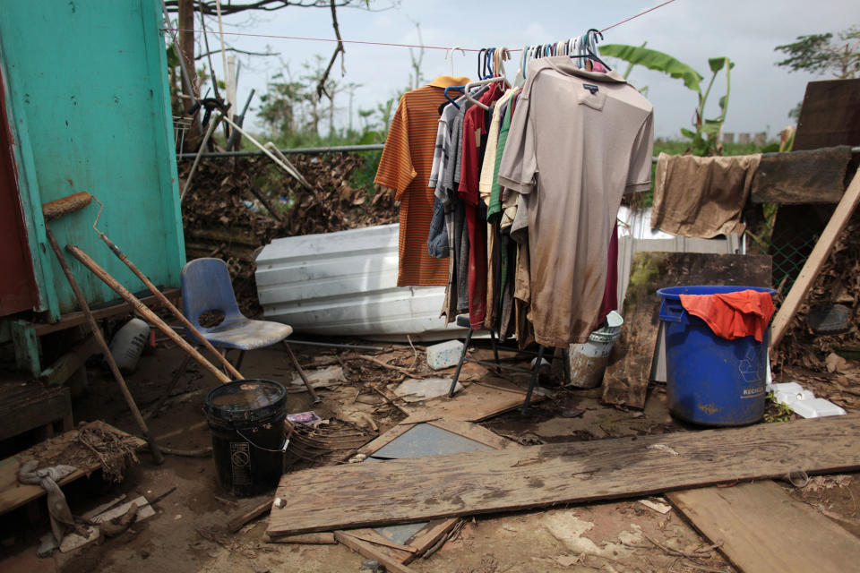 <p>Clothes are seen on a rack outside a home, after Hurricane Maria hit the island in September, in Toa Baja, Puerto Rico, Oct. 18, 2017. (Photo: Alvin Baez/Reuters) </p>