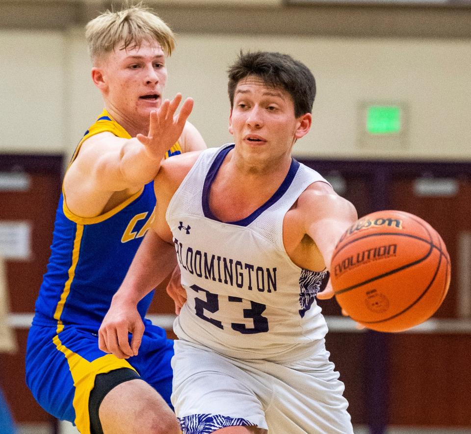 South's Taye Spears (23) passes around Castle's Brayden Bishop (1) during the Bloomington South versus Castle boys basketball game at Bloomington High School South on Friday, Jan. 20, 2023.