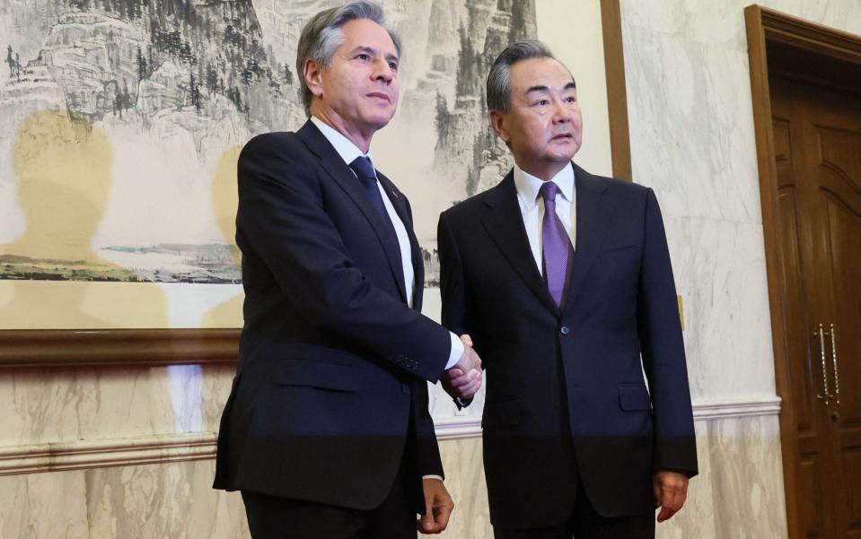 US Secretary of State Antony Blinken (L) shakes hands with China's Director of the Office of the Central Foreign Affairs Commission Wang Yi